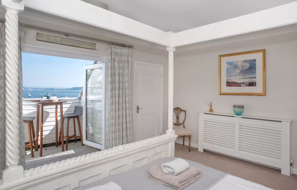 Cawsand Cornwall sea view house coastal village home ocean view A seaside home in Cawsand overlooking the ocean, with views across the water and nearby coastline. The setting feels peaceful, surrounded by a quiet coastal village.